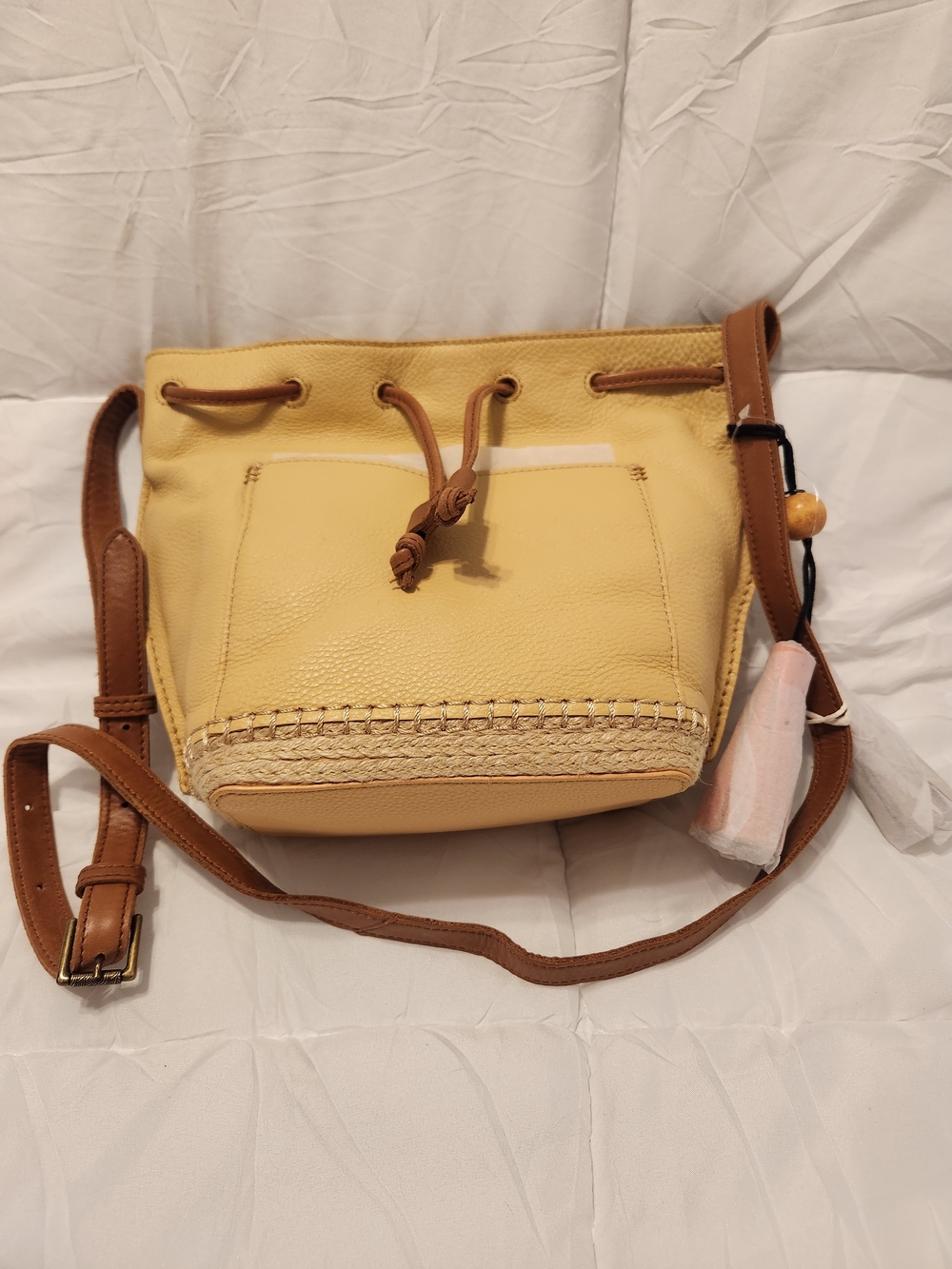 The Sak Yellow Drawstring Crossbody with Brown Trim and Woven Base
